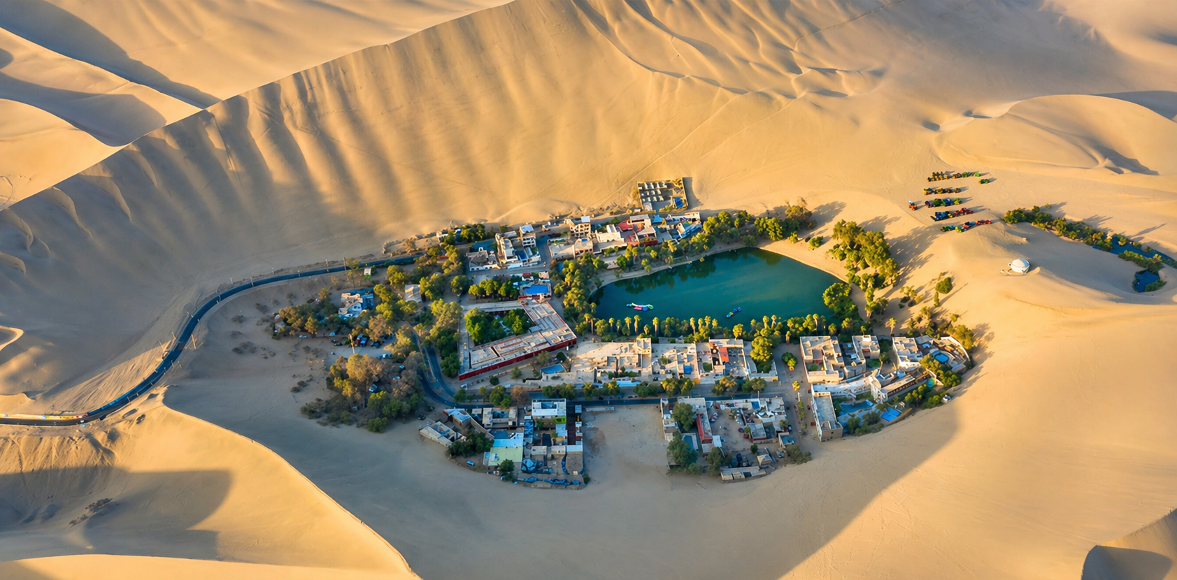 Aerial view of Huacachina oasis surrounded by dunes